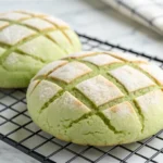 Freshly baked matcha pan with a crispy, crisscross-patterned cookie topping, cooling on a wire rack